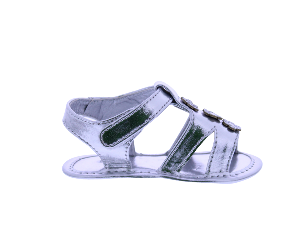 Silver sandal with decorative straps on a white background