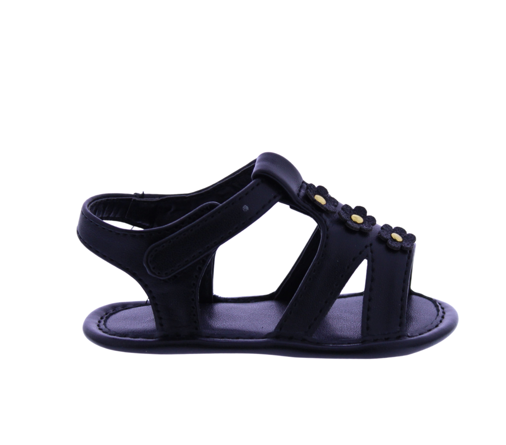 Black sandal with gold accents on a white background