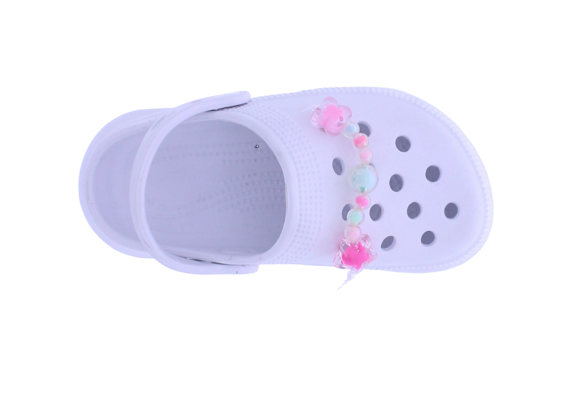 A single white plastic clog-style shoe with decorative pastel beads and pink pom-poms across the top, shown on a plain white background.