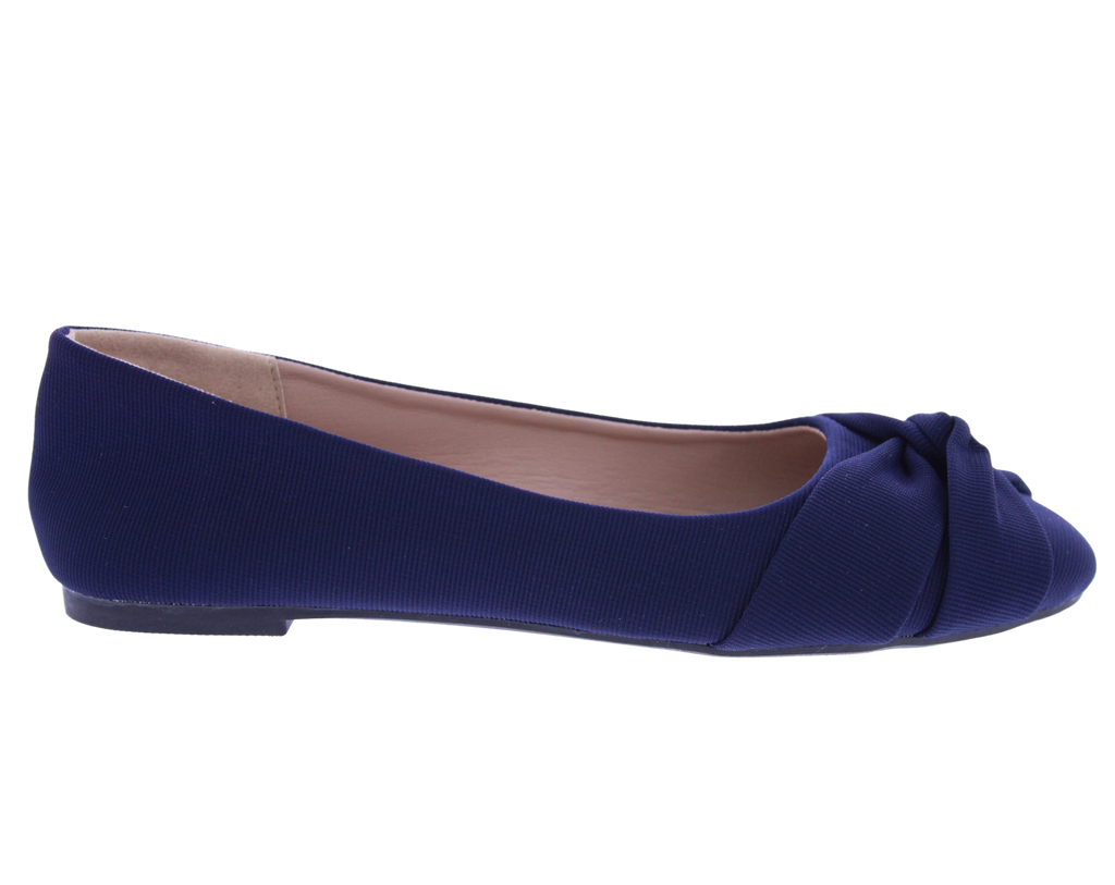 Navy blue flat shoe with a bow on a white background